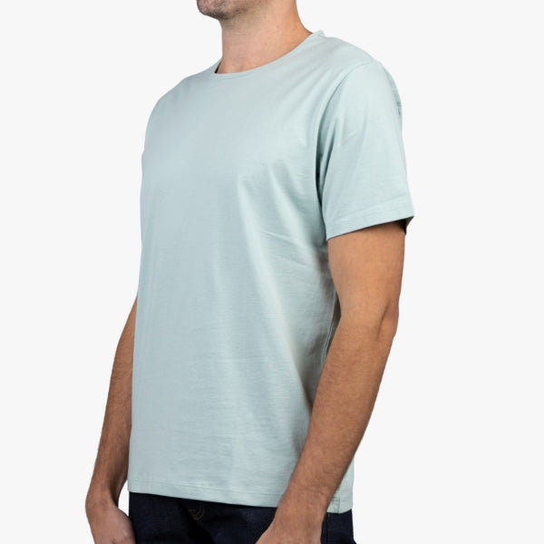 Light Green T-Shirt on Model Facing Forward at an Angle